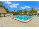 Community pool with surrounding lounge chairs and building in background at 2400 Winding Creek Blvd # 24-203, Clearwater, FL 33761