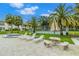 Relax by the pool and spa with lounge chairs and a shaded table at 2400 Winding Creek Blvd # 24-203, Clearwater, FL 33761