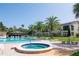 Community pool and spa with lounge chairs at 2400 Winding Creek Blvd # 24-203, Clearwater, FL 33761