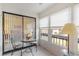 Sunroom with glass-top table and chairs, offering view of bedroom at 2400 Winding Creek Blvd # 24-203, Clearwater, FL 33761