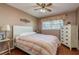 Bright bedroom with striped bedding and wood floors at 2447 Ecuadorian Way # 1, Clearwater, FL 33763