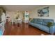 Spacious living room with hardwood floors, large sofa, and built-in shelving at 2447 Ecuadorian Way # 1, Clearwater, FL 33763