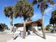 Beachfront restrooms with palm trees and signage at 2707 1 St, Indian Rocks Beach, FL 33785