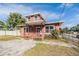 Exterior of a two-story orange house with porch and fenced yard at 3306 N Howard Ave, Tampa, FL 33607