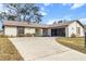 House with a screened patio and a long driveway at 3324 Harrow Road, Spring Hill, FL 34606