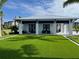 Community clubhouse with outdoor seating and turf at 7244 Sutton Ln, Sarasota, FL 34240