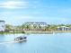 Community boat on the lake with apartment buildings in the background at 7244 Sutton Ln, Sarasota, FL 34240