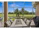 Enclosed patio with table and chairs, offering scenic golf course views at 7286 Maidencane Ct, Seminole, FL 33777