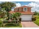 Two-story house with tile roof and landscaped yard at 7286 Maidencane Ct, Seminole, FL 33777