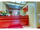 Red vanity with mirror and tiled floor at 81 Gulfwinds Dr, Palm Harbor, FL 34683