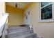 Front entrance with white double doors and gray tile flooring at 81 Gulfwinds Dr, Palm Harbor, FL 34683