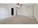 Bright bedroom featuring carpet, ceiling fan and an adjacent closet at 815 Village Way, Palm Harbor, FL 34683