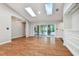 Light-filled living room, hardwood floors, skylights, and sliding glass doors at 815 Village Way, Palm Harbor, FL 34683