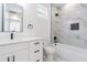 Contemporary bathroom featuring white vanity, modern fixtures, and a tiled shower-tub combination at 925 E Chelsea St, Tampa, FL 33603