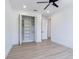 Spacious bedroom featuring wood-look floors, a fan, a closet, and neutral paint at 925 E Chelsea St, Tampa, FL 33603