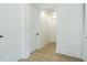 Bright hallway with wood-look floors provides access to multiple rooms within the home at 925 E Chelsea St, Tampa, FL 33603