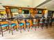 Full bar area with stools, lighting, and ample seating at 9460 Discovery Ter # 201C, Bradenton, FL 34212