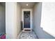 Welcoming entryway featuring a gray door, wreath, 'Welcome' sign, and 'Only Good Vibes' doormat on a paved walkway at , Odessa, FL 33556