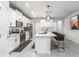 Bright kitchen features stainless appliances, white cabinetry, pendant lighting, and quartz countertops at , Odessa, FL 33556