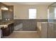 Elegant bathroom featuring granite countertops, dark wood cabinets, and mosaic tile at 10514 Sleepy Orange Ct, Riverview, FL 33578