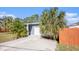 Home's exterior featuring a gray painted brick, white garage door, and a wooden fence at 139 Tennessee Ne Ave, St Petersburg, FL 33702