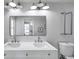 Double vanity bathroom with modern fixtures and a large mirror at 14491 Passage Way, Seminole, FL 33776