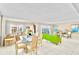 Living room with lime green sofa, glass top table, and water views at 1480 Gulf Blvd # 1107, Clearwater Beach, FL 33767