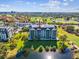 Condo building's aerial view, highlighting its proximity to a lake and golf course at 14810 Rue De Bayonne # 7F, Clearwater, FL 33762