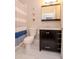 Updated bathroom with dark vanity, marble countertop and nautical-themed decor at 1814 E 15Th Ave, Tampa, FL 33605