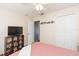 Spacious bedroom with double bed, built-in shelving, and TV at 25028 Hyde Park Blvd, Land O Lakes, FL 34639