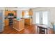 Kitchen with island, stainless steel appliances, and wood cabinets at 25028 Hyde Park Blvd, Land O Lakes, FL 34639