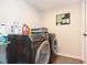 Convenient laundry room with washer, dryer, and storage at 25028 Hyde Park Blvd, Land O Lakes, FL 34639