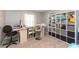 Home office with desk, shelving unit, and comfortable chair at 25028 Hyde Park Blvd, Land O Lakes, FL 34639
