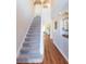 Staircase with carpet and hardwood floors in the hallway at 25028 Hyde Park Blvd, Land O Lakes, FL 34639