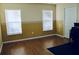 Bright bedroom with two windows, wood flooring and a large closet at 31216 Masena Dr, Wesley Chapel, FL 33545