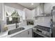 Modern kitchen with white shaker cabinets and stainless steel appliances at 319 Francis Dr, Apollo Beach, FL 33572