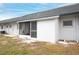 The back exterior of the home features the patio with open backyard and neutral exterior at 4444 Swift Rd # 20, Sarasota, FL 34231