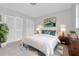 Cozy bedroom with a plush white bed, closet, stylish decor, and soft, neutral tones at 4444 Swift Rd # 20, Sarasota, FL 34231