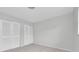 Neutral bedroom features closet with louvered doors and carpeted floor at 4444 Swift Rd # 20, Sarasota, FL 34231
