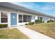 Inviting condo showcasing bright exterior, complemented by a well-maintained lawn and walkway at 4444 Swift Rd # 20, Sarasota, FL 34231