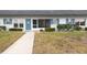 Charming condo with blue accents, screen door, and manicured landscaping offers a welcoming exterior at 4444 Swift Rd # 20, Sarasota, FL 34231