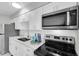 Modern kitchen featuring white cabinets, stainless steel appliances, and elegant countertops for a stylish cooking experience at 4444 Swift Rd # 20, Sarasota, FL 34231