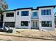 Two-story modern home with white brick exterior and dark trim at 4608 S Ferdinand Ave, Tampa, FL 33611