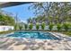 Stunning rectangular pool features a built-in spa, travertine deck, and plenty of space for outdoor entertaining at 4608 S Ferdinand Ave, Tampa, FL 33611