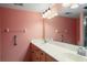 Bathroom with double vanity and light pink walls at 4859 Independence Dr, Bradenton, FL 34210