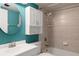 Clean bathroom with teal walls, white vanity, and a shower/tub combo at 4859 Independence Dr, Bradenton, FL 34210