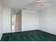 Bedroom with green carpet, ceiling fan, and large closet at 4859 Independence Dr, Bradenton, FL 34210