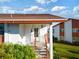 Condo entrance with stairs and landscaping at 4859 Independence Dr, Bradenton, FL 34210