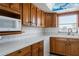 Kitchen boasts wood cabinets, tile countertops, and a window at 4859 Independence Dr, Bradenton, FL 34210