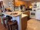 Kitchen with wood cabinets, tile counters, and appliances at 506 Lennox W Rd # 506, Palm Harbor, FL 34683